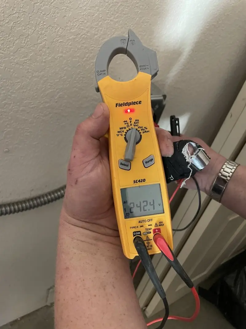 Voltage testing with clamp meter during Electrical Installation Services in Crowley